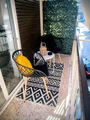 two chairs and a table on a porch at S-eva resort athens apartments 2 in Athens