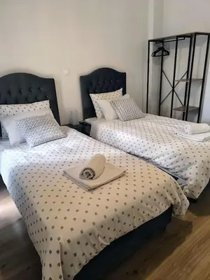 a bedroom with two beds with a hat on it at S-eva resort athens apartments 2 in Athens