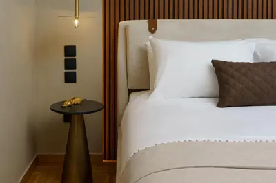 a bedroom with a bed with a table next to it at ESTER Metropolitan Luxe - 2 Bedrooms 2 Bathrooms in Athens