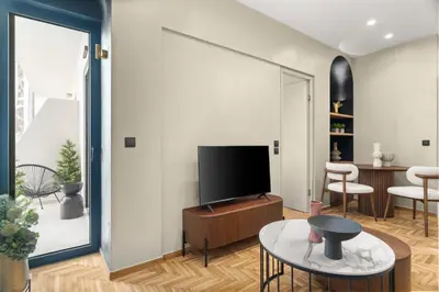 a living room with a tv and a table at ESTER Metropolitan Luxe - 2 Bedrooms 2 Bathrooms in Athens