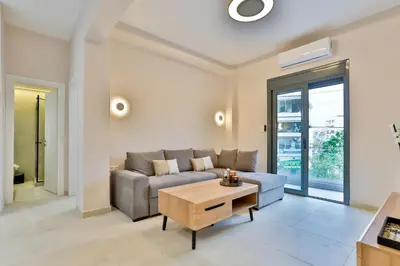 a living room with a couch and a table at South Athens Apts New Collection by Live & Travel in Athens