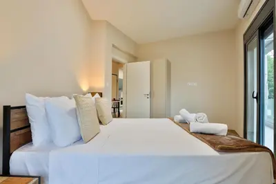 a bedroom with a large white bed with white pillows at South Athens Apts New Collection by Live & Travel in Athens
