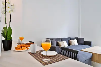 a dining room table with a glass of orange juice at South Athens Apts New Collection by Live & Travel in Athens