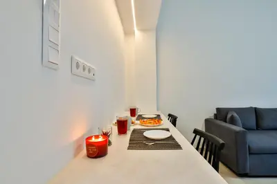 a table with a plate of food and a couch at South Athens Apts New Collection by Live & Travel in Athens