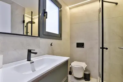 a bathroom with a sink and a shower at South Athens Apts New Collection by Live & Travel in Athens