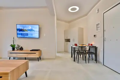 a living room with a table and chairs at South Athens Apts New Collection by Live & Travel in Athens