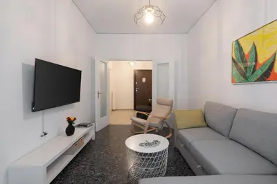 a living room with a couch and a flat screen tv at Cozy Apartment in Athens with Balcony, 5 min to Metro in Athens