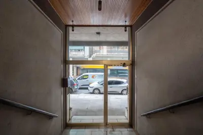 an open door to a parking lot with cars parked at 15 mins Walk to Acropolis, Minimalist Studio in Athens