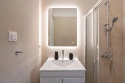 a bathroom with a sink and a shower with a mirror at 15 mins Walk to Acropolis, Minimalist Studio in Athens