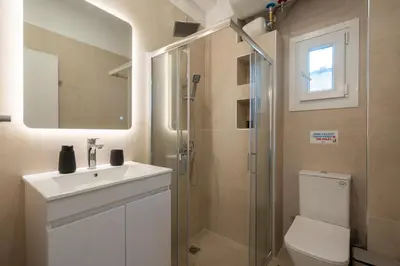 a bathroom with a toilet and a sink and a shower at 15 mins Walk to Acropolis, Minimalist Studio in Athens