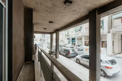 a balcony with cars parked on a city street at 15 mins Walk to Acropolis, Minimalist Studio in Athens