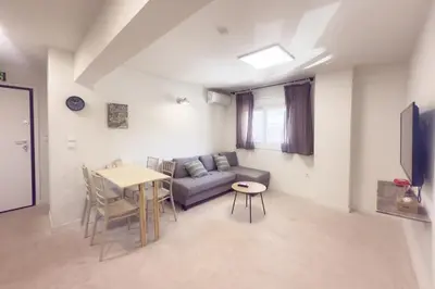 a living room with a couch and a table at Panormou Neon - Urban Apartment 1A in Athens