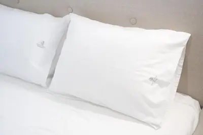 two white pillows sitting on top of a bed at Panormou Neon - Urban Apartment 1A in Athens
