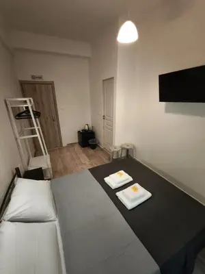 a room with a bed with two plates on it at Beehive Mini Rooms in Athens