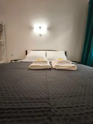 a bedroom with a bed with two towels on it at Beehive Mini Rooms in Athens