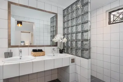 a bathroom with two sinks and a mirror at Elaia House Glyfada in Athens