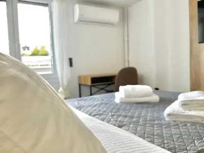 a bedroom with a bed with towels on it at New Sleek apartment in the center of AThens in Athens
