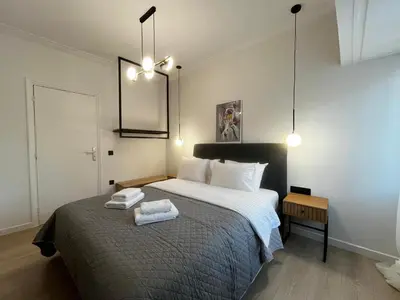 a bedroom with a bed with two towels on it at New Sleek apartment in the center of AThens in Athens
