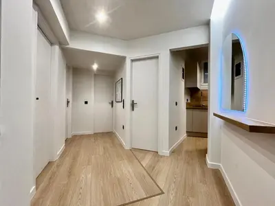 an empty hallway with white walls and wood floors at New Sleek apartment in the center of AThens in Athens