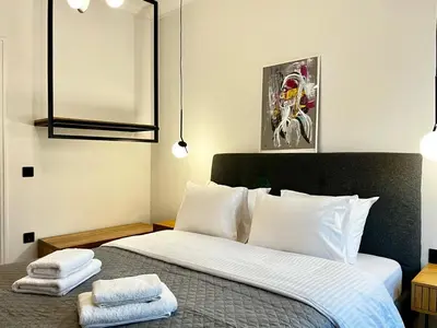 a bedroom with a bed with two towels on it at New Sleek apartment in the center of AThens in Athens
