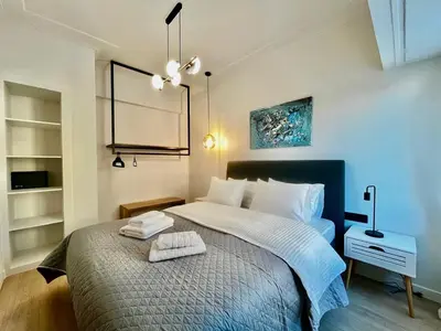 a bedroom with a bed with two towels on it at New Sleek apartment in the center of AThens in Athens