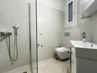 a bathroom with a shower and a toilet and a sink at New Sleek apartment in the center of AThens in Athens