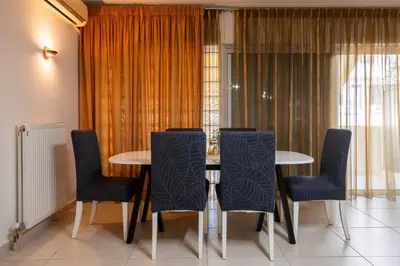 a dining room with a table and chairs at Spacious 2BR, hot tub, prvt parking, near metro in Athens