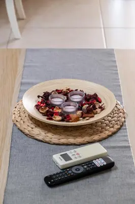 a plate of cupcakes on a table with a remote control at Spacious 2BR, hot tub, prvt parking, near metro in Athens