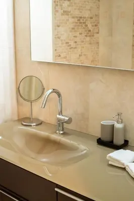a bathroom counter with a sink and a mirror at Spacious 2BR, hot tub, prvt parking, near metro in Athens