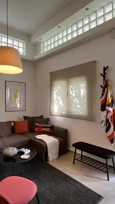 a living room with a couch and a table at Lemon & Roses in Athens