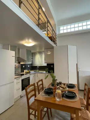 a kitchen with a wooden table and chairs in it at Lemon & Roses in Athens