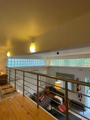 a room with wooden floors and a balcony with windows at Lemon & Roses in Athens