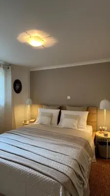 a bedroom with a large bed with white pillows at Lemon & Roses in Athens