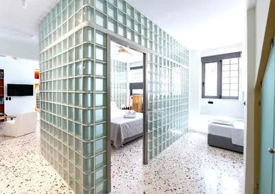 a room with a wall of glass at Glass Nest Athens 2BR Apartment near Metro & Airport Line in Athens