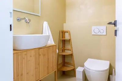 a bathroom with a sink and a toilet at Glass Nest Athens 2BR Apartment near Metro & Airport Line in Athens