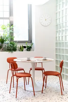 a table and chairs in a room with a clock at Glass Nest Athens 2BR Apartment near Metro & Airport Line in Athens