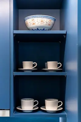a shelf with three cups and a bowl on it at Glass Nest Athens 2BR Apartment near Metro & Airport Line in Athens