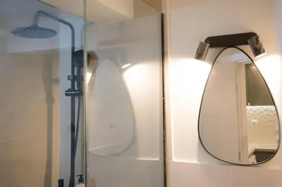 a bathroom with a mirror and a shower at Panormou Neon - Urban Apartment 1B in Athens