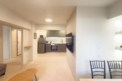 a kitchen and dining room with a table and chairs at Panormou Neon - Urban Apartment 1B in Athens