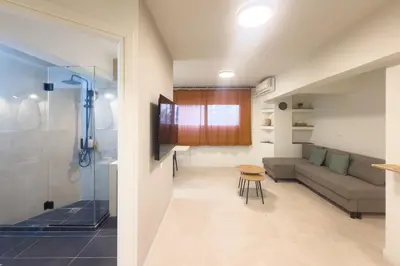 a living room with a couch and a shower at Panormou Neon - Urban Apartment 1B in Athens