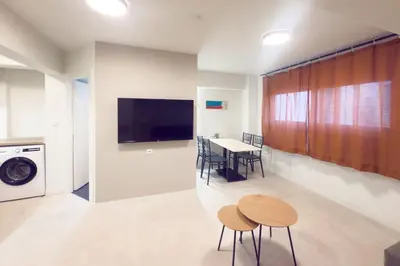 a kitchen and dining room with a table and chairs at Panormou Neon - Urban Apartment 1B in Athens