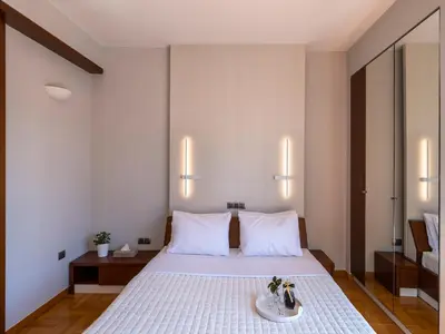 a hotel room with a bed with a plate on it at Phos, an eclectic suite with stunning Acropolis view in Athens