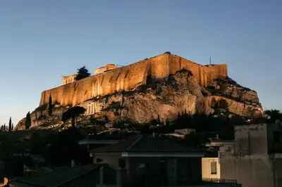 a mountain with a house in front of it at Phos, an eclectic suite with stunning Acropolis view in Athens