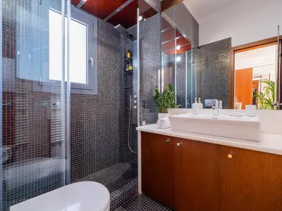 a bathroom with a sink and a shower and a toilet at Phos, an eclectic suite with stunning Acropolis view in Athens