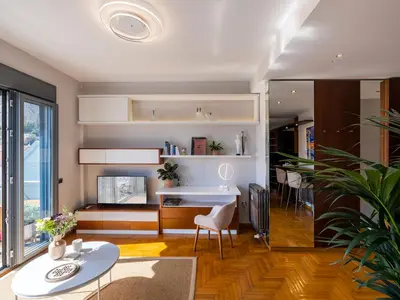 a living room with a table and a dining room at Phos, an eclectic suite with stunning Acropolis view in Athens