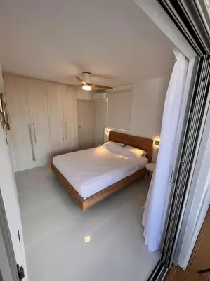 a small bedroom with a bed and a window at Amelia luxury beachfront apartment near airport in Porto Rafti
