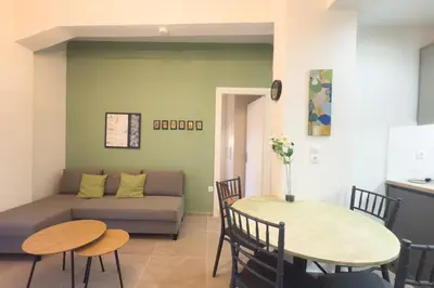 a living room with a couch and a table at Panormou Neon - Urban Apartment 2B in Athens
