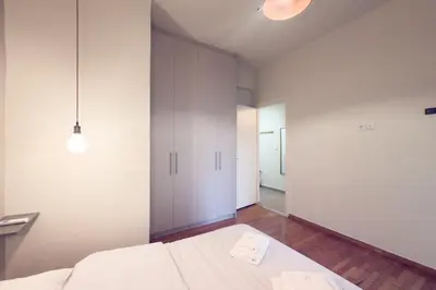 a bedroom with a bed and a large closet at Panormou Neon - Urban Apartment 2B in Athens