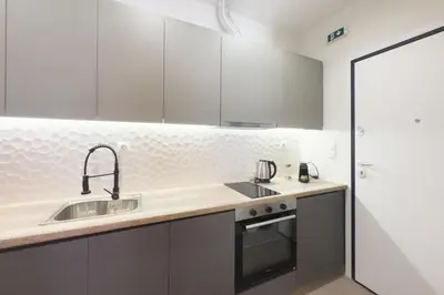 a kitchen with white cabinets and a sink at Panormou Neon - Urban Apartment 2A in Athens