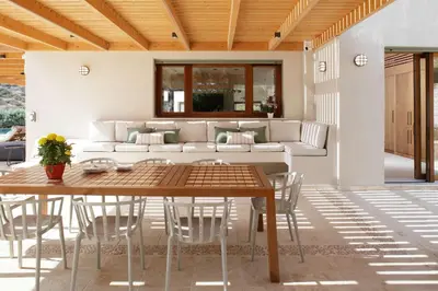 a living room with a table and a couch at Villa Lithos in Porto Rafti